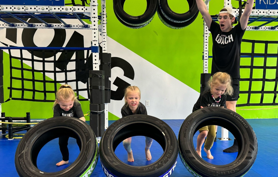 Kids flipping tires in KidStrong class